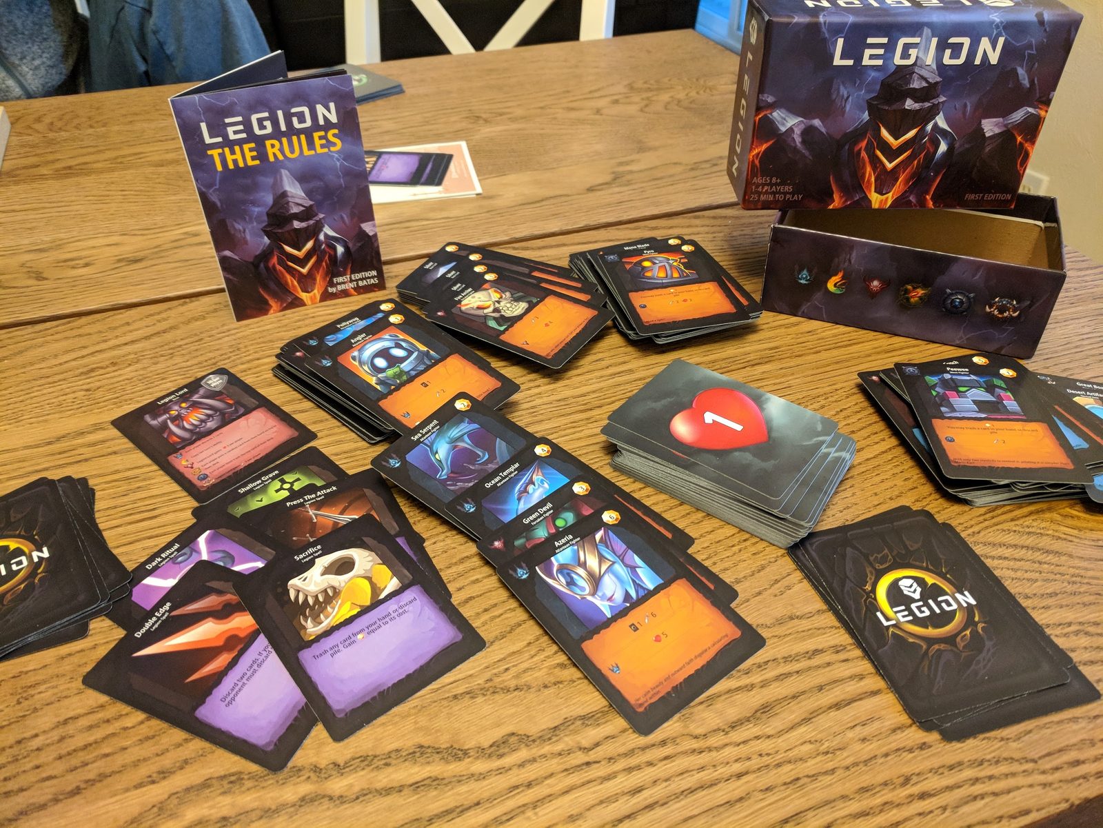 Legion cards, rules, and box laid out on a table